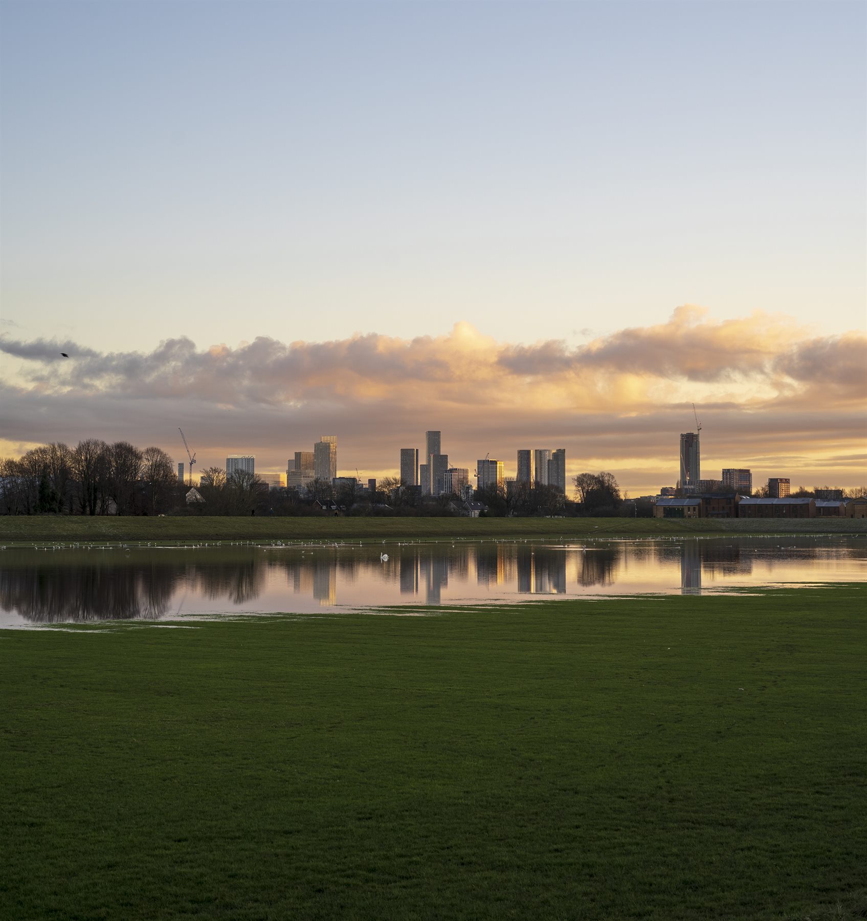 Manchester skyline reflected in water by Peter Szafel