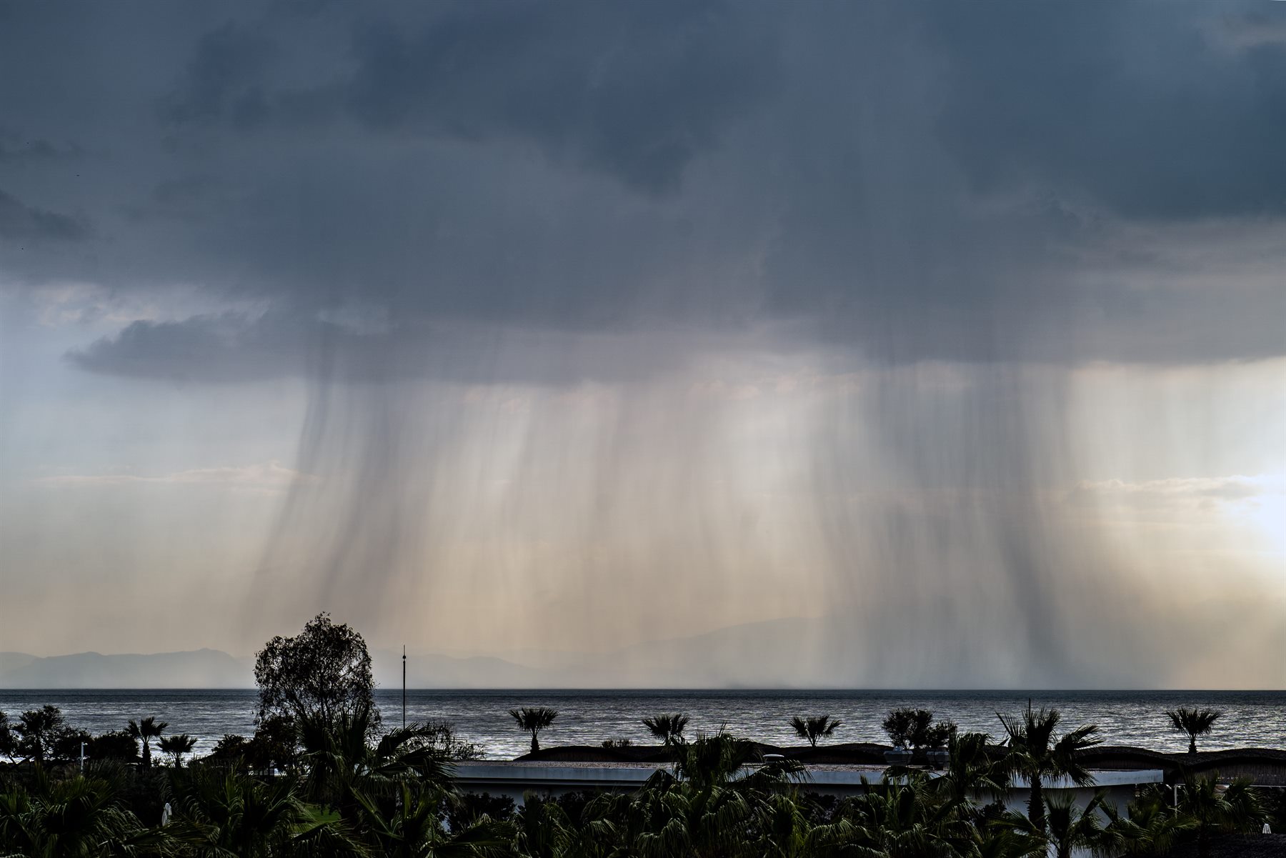 Rain falling over the sea by Peter Szafel